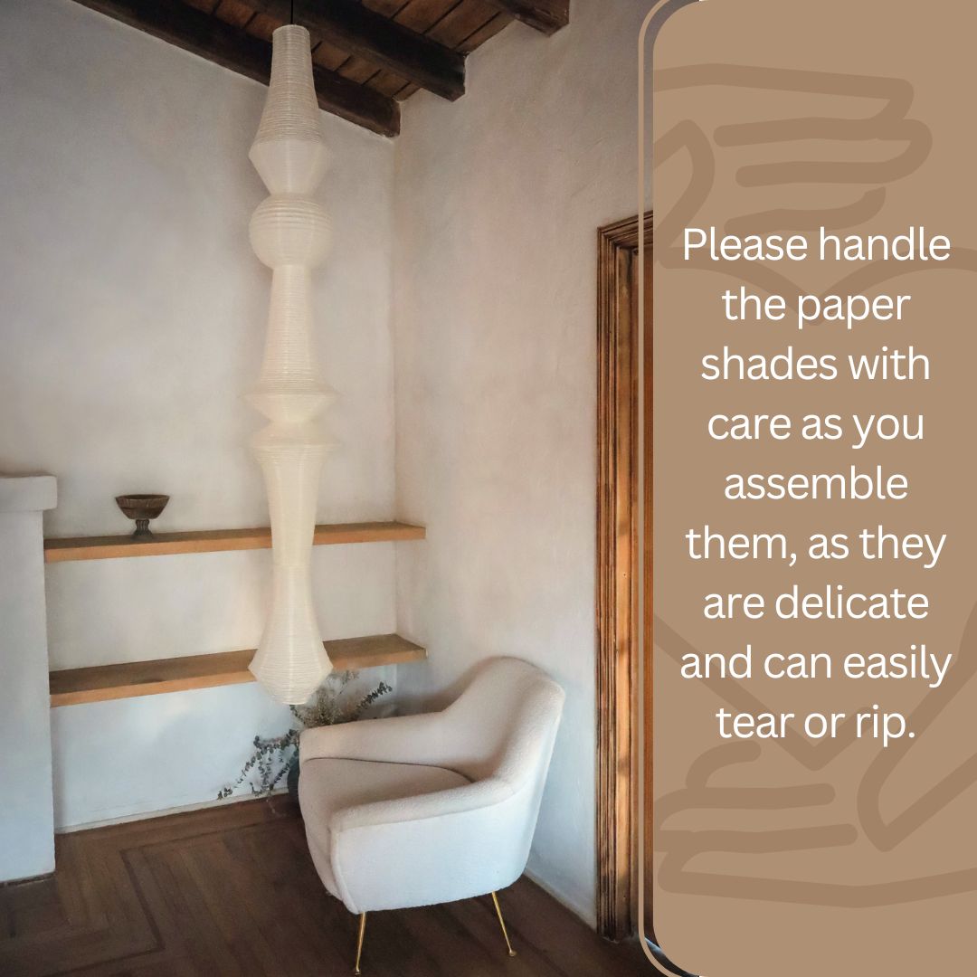 Japanese paper lantern with an elegant design displayed in a minimalist corner, accompanied by an advisory to handle the delicate paper shades with care during assembly to avoid tearing or ripping