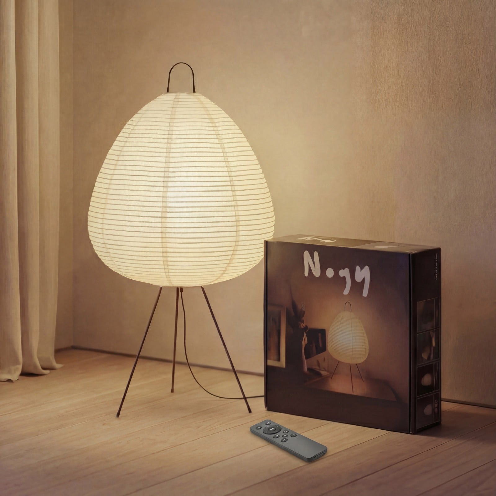 Akari Noguchi Japanese paper lamp with metal frame lit in warm room light.