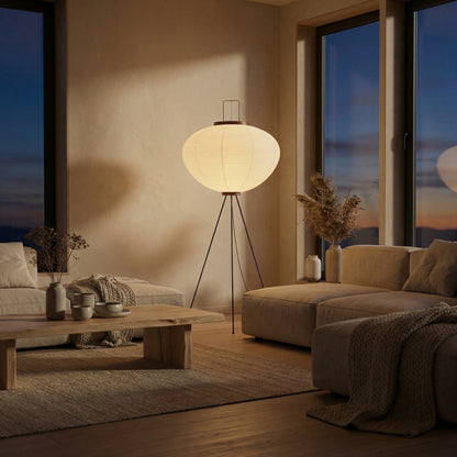 Akari style tripod floor lamp providing warm ambient light at night

