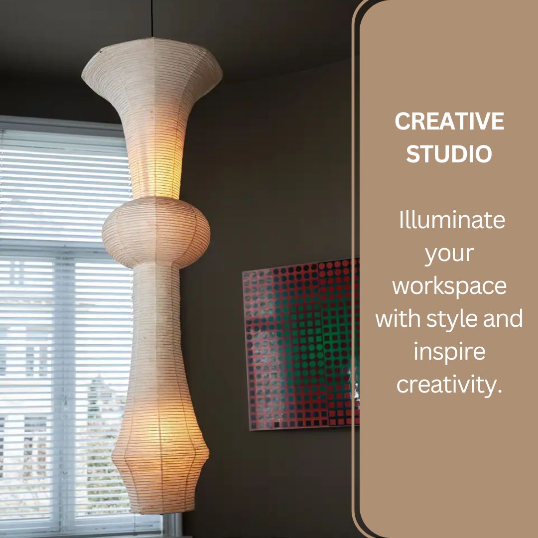 Handcrafted white Japanese rice paper pendant light illuminating a creative studio workspace