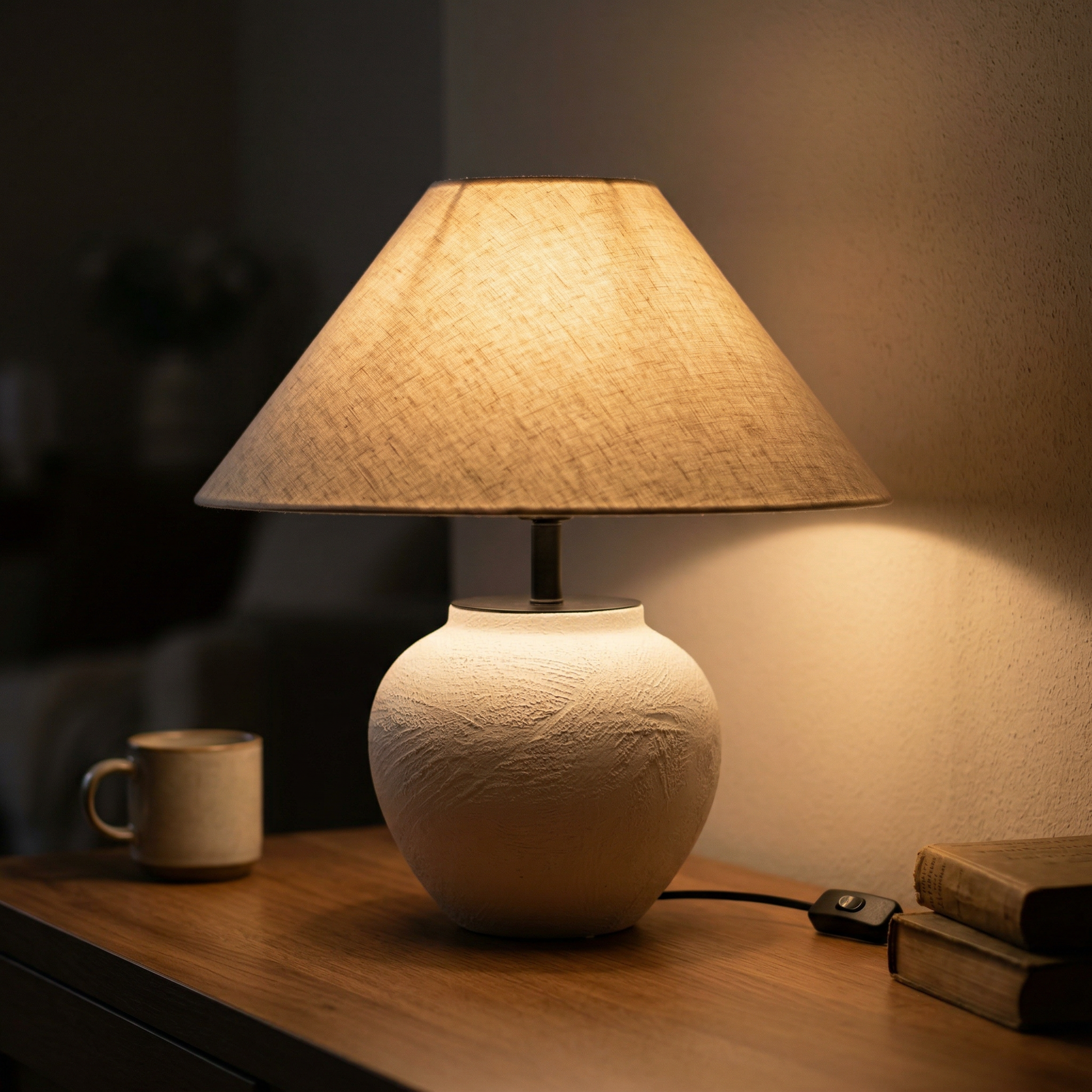 Nogy round Japandi ceramic table lamp  illuminating a cozy corner