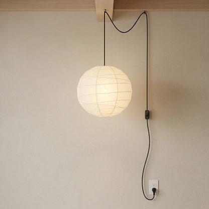 Japandi style plug-in rice paper globe pendant lantern with a round white paper shade and black cord