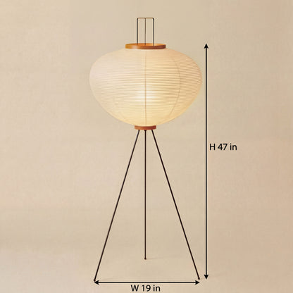 Noguchi-style Japanese tripod floor lamp with a rice paper shade, measuring 47 inches in height and 19 inches in width, casting a soft warm ambient glow in a minimalist interior.