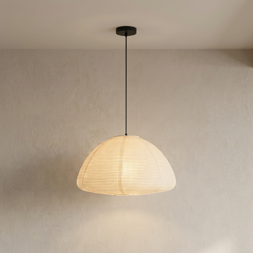 Japanese-inspired dome-shaped rice paper pendant light with metal ribbing, illuminated to show a soft, warm glow.