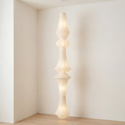 A long sculptural washi paper lamp in an open-concept space, styled for a modern minimalist luxury apartment with soft ambient lighting.