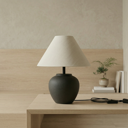 Minimalist charcoal ceramic table lamp with rounded ceramic base and warm linen shade for Japandi and Scandinavian interiors