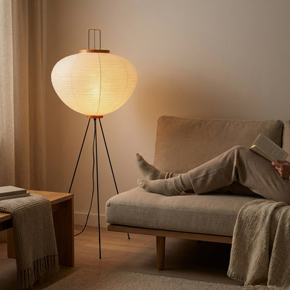 Rice paper floor lamp illuminating a cozy reading corner
