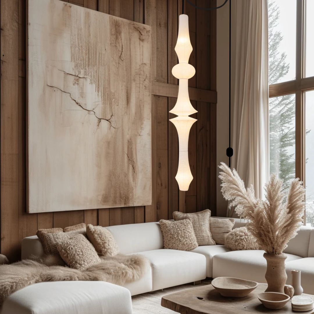 A large sculptural rice paper lamp illuminating a luxurious, modern high-rise living room