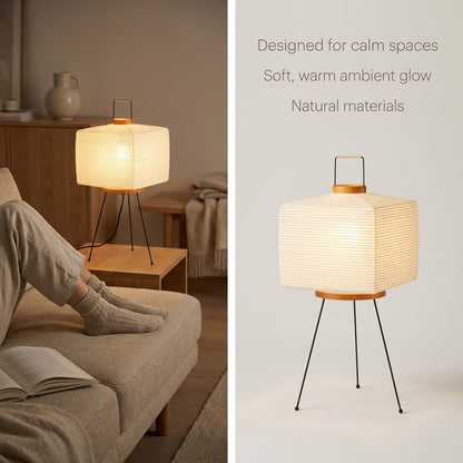 Square paper floor lamp illuminating a calm living room space with a sofa and side table.